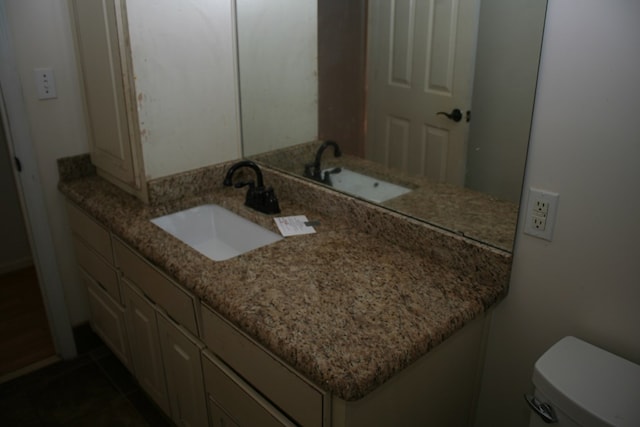 bathroom with tile patterned floors, vanity, and toilet