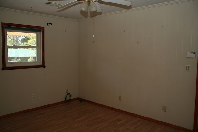 spare room with ceiling fan, dark hardwood / wood-style floors, and ornamental molding