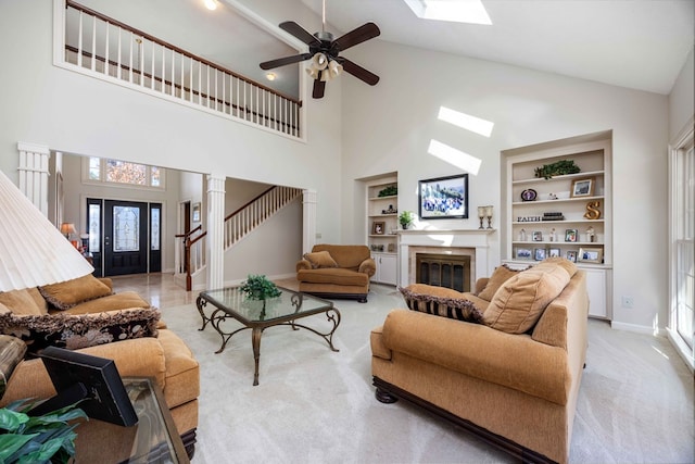 living room with built in features, light carpet, high vaulted ceiling, and ceiling fan