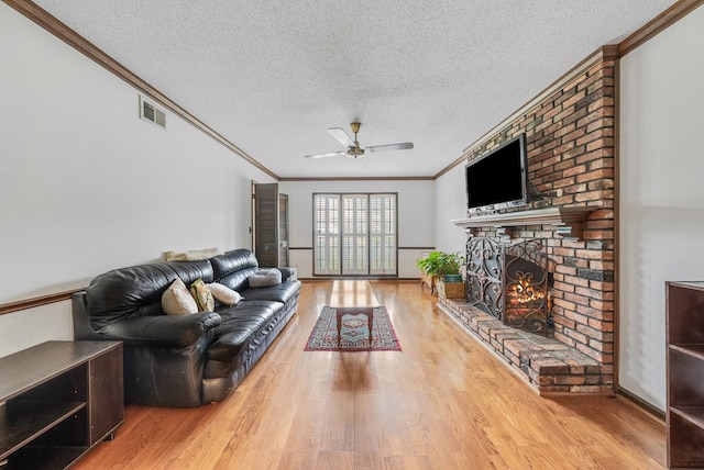 438 Newport Pl, Columbus, GA 31904 - living area with crown molding, a textured ceiling, ceiling fan, wood finished floors, and a brick fireplace