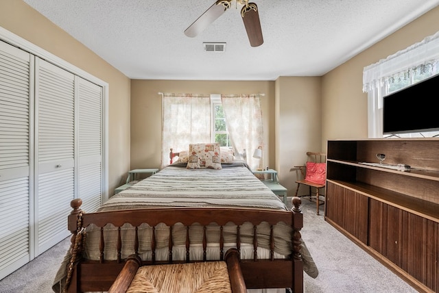 438 Newport Pl, Columbus, GA 31904 - bedroom with light colored carpet, a closet, a textured ceiling, and a ceiling fan