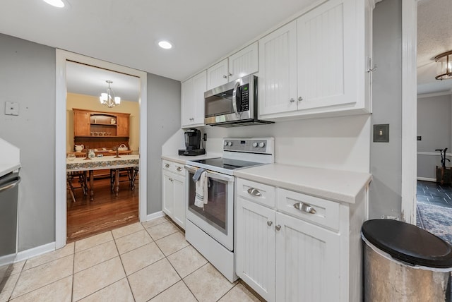 438 Newport Pl, Columbus, GA 31904 - kitchen featuring electric range, stainless steel microwave, white cabinetry, light countertops, and recessed lighting
