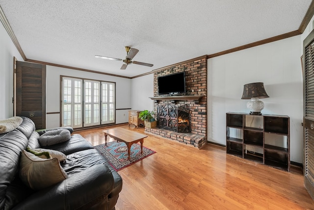 438 Newport Pl, Columbus, GA 31904 - living area with ornamental molding, ceiling fan, wood finished floors, a textured ceiling, and a fireplace