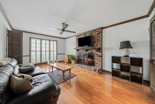 438 Newport Pl, Columbus, GA 31904 - living room featuring crown molding, wood finished floors, ceiling fan, a textured ceiling, and a brick fireplace