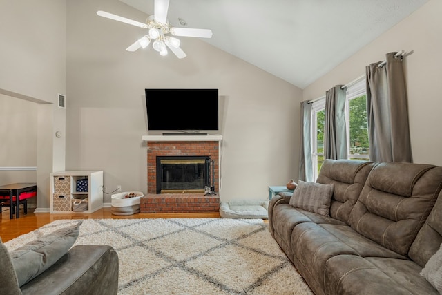 6538 Middleburg Dr, Columbus, GA 31909 - living room with high vaulted ceiling, a ceiling fan, a brick fireplace, and wood finished floors