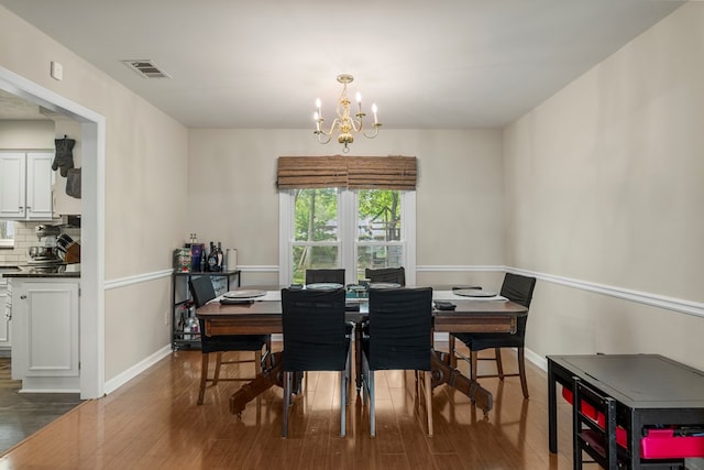 6538 Middleburg Dr, Columbus, GA 31909 - dining room featuring wood finished floors, a chandelier, and baseboards