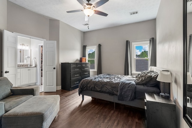 6538 Middleburg Dr, Columbus, GA 31909 - bedroom featuring dark wood-style floors, multiple windows, ensuite bath, and a ceiling fan
