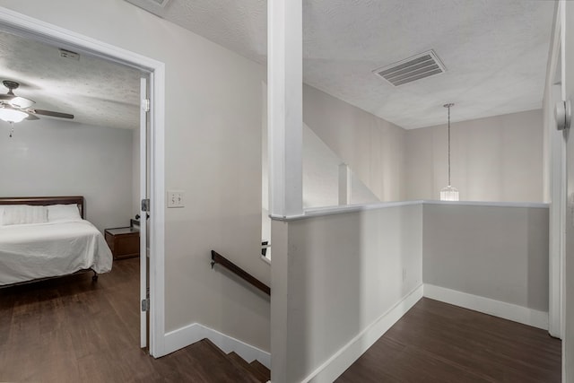 6538 Middleburg Dr, Columbus, GA 31909 - hallway featuring an upstairs landing, a textured ceiling, dark wood finished floors, and baseboards
