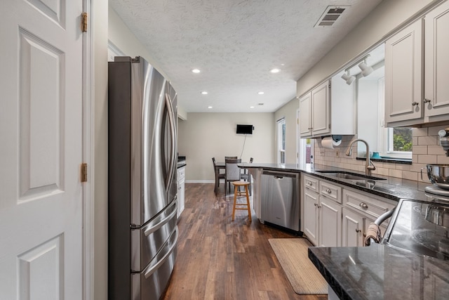 6538 Middleburg Dr, Columbus, GA 31909 - kitchen with stainless steel appliances, a sink, dark wood-style flooring, backsplash, and recessed lighting