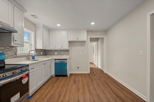 1712 39th St, Phenix City, AL 36867 - kitchen featuring dishwasher, electric range, light wood finished floors, decorative backsplash, and white cabinets