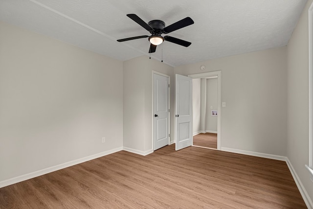 1712 39th St, Phenix City, AL 36867 - empty room featuring light wood-style flooring, a ceiling fan, and a textured ceiling
