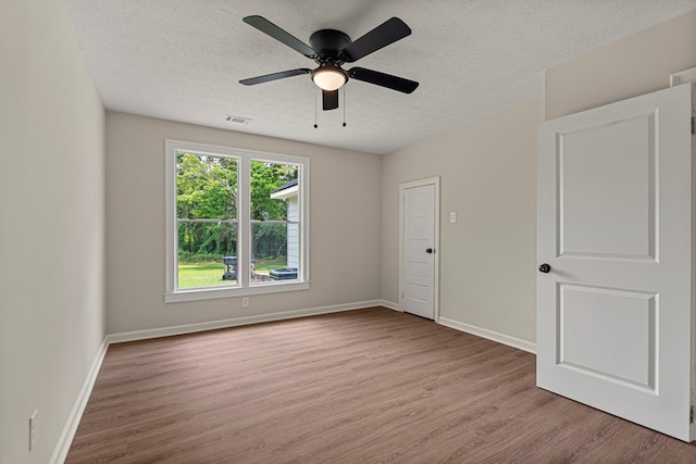 1712 39th St, Phenix City, AL 36867 - empty room featuring light wood-type flooring, a textured ceiling, and ceiling fan