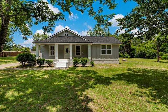 1712 39th St, Phenix City, AL 36867 - view of front of home featuring covered porch, a shingled roof, a front yard, board and batten siding, and crawl space