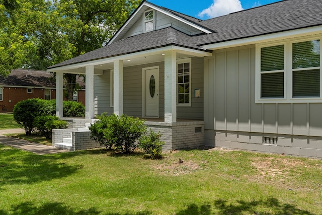 1712 39th St, Phenix City, AL 36867 - entrance to property with board and batten siding, a shingled roof, a yard, and covered porch