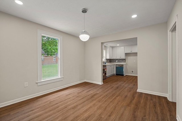 1712 39th St, Phenix City, AL 36867 - kitchen featuring wood finished floors, recessed lighting, white cabinetry, dishwashing machine, and hanging light fixtures