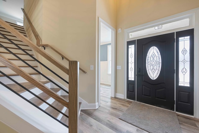 entrance foyer with plenty of natural light, light wood-style flooring, and baseboards