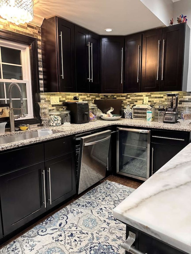 1314 Talbotton Rd, Columbus, GA 31901 - kitchen featuring beverage cooler, stainless steel dishwasher, decorative backsplash, light stone countertops, and light wood finished floors