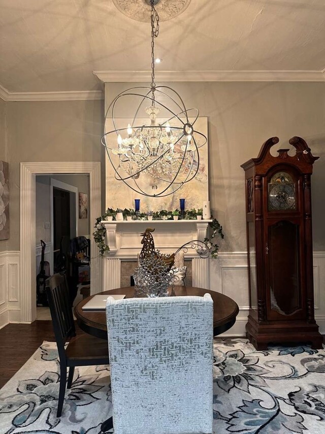 1314 Talbotton Rd, Columbus, GA 31901 - dining area with a chandelier, a decorative wall, wood finished floors, crown molding, and a wainscoted wall