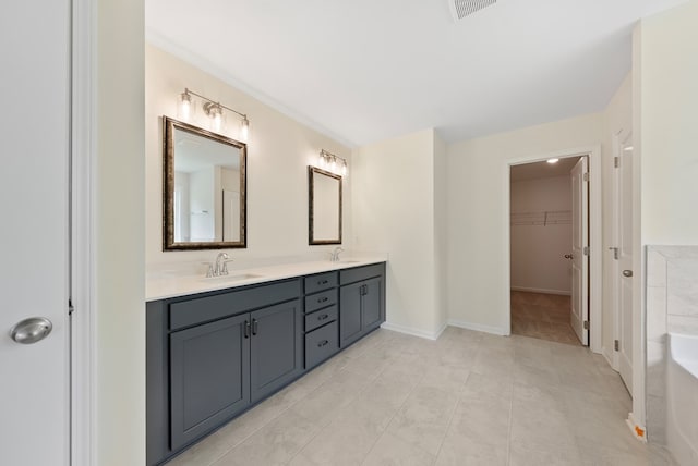 2276 Webbed Way, Opelika, AL 36804 - bathroom with double vanity, a spacious closet, a bath, and tile patterned floors