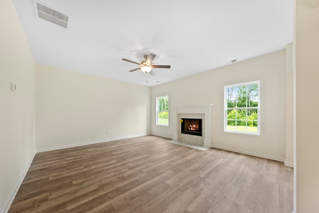 2276 Webbed Way, Opelika, AL 36804 - unfurnished living room with wood finished floors, ceiling fan, and a premium fireplace