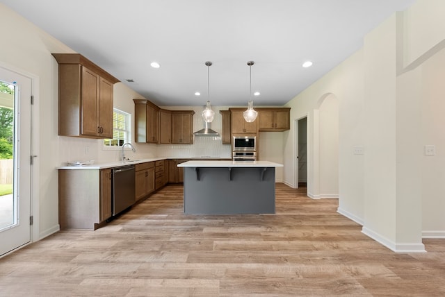 2276 Webbed Way, Opelika, AL 36804 - kitchen with stainless steel appliances, light wood-style floors, a kitchen island, decorative backsplash, and recessed lighting