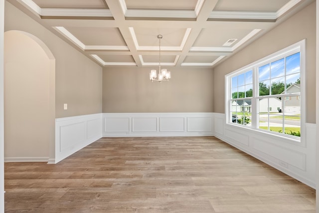2276 Webbed Way, Opelika, AL 36804 - spare room with a chandelier, coffered ceiling, beam ceiling, light wood-style flooring, and arched walkways