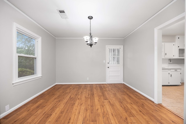 1402 41st St, Columbus, GA 31904 - unfurnished dining area featuring a chandelier, ornamental molding, baseboards, and light wood-style floors