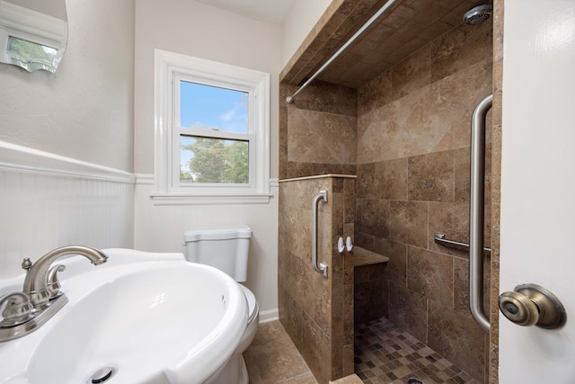 1402 41st St, Columbus, GA 31904 - bathroom featuring a sink, a stall shower, a wainscoted wall, and toilet