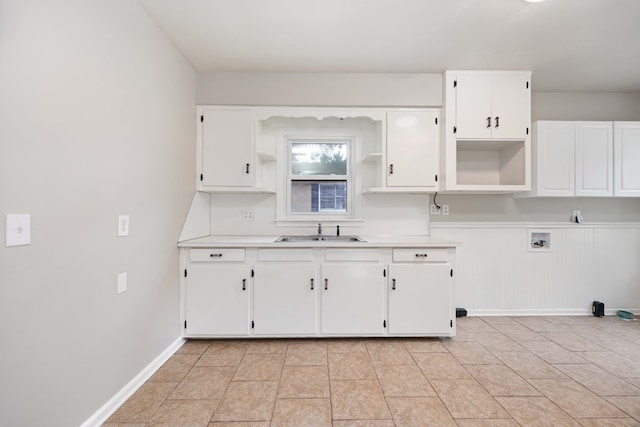1402 41st St, Columbus, GA 31904 - kitchen featuring open shelves, a sink, white cabinetry, light countertops, and baseboards
