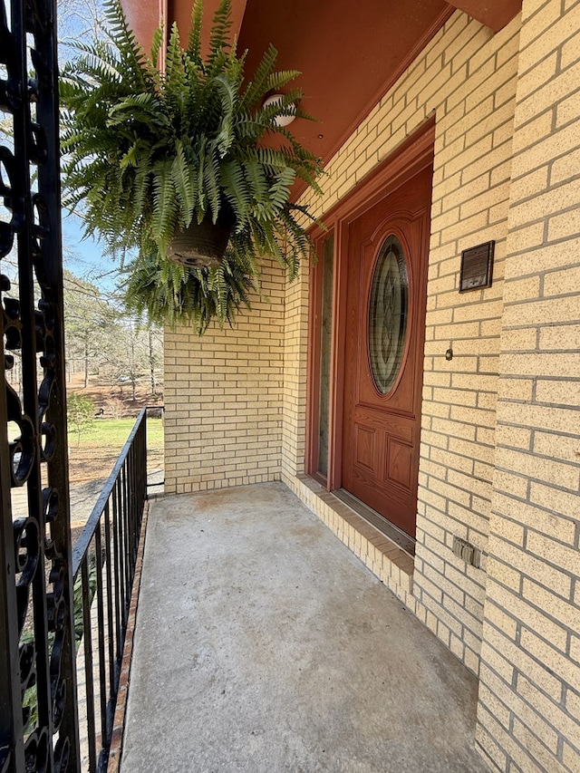 view of exterior entry with brick siding