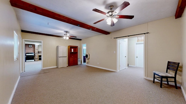 interior space with beam ceiling, carpet flooring, and a barn door