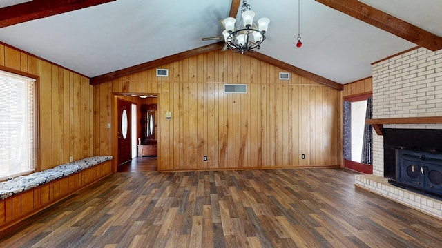 unfurnished living room with visible vents, vaulted ceiling with beams, and wood finished floors