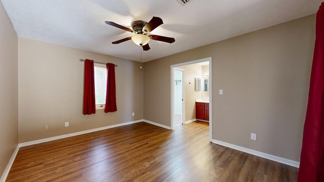 unfurnished room featuring dark wood-type flooring, baseboards, and ceiling fan