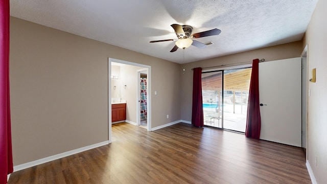 spare room featuring ceiling fan, baseboards, a textured ceiling, and wood finished floors