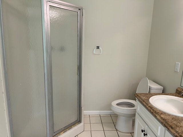 full bathroom featuring vanity, toilet, tile patterned floors, baseboards, and a stall shower