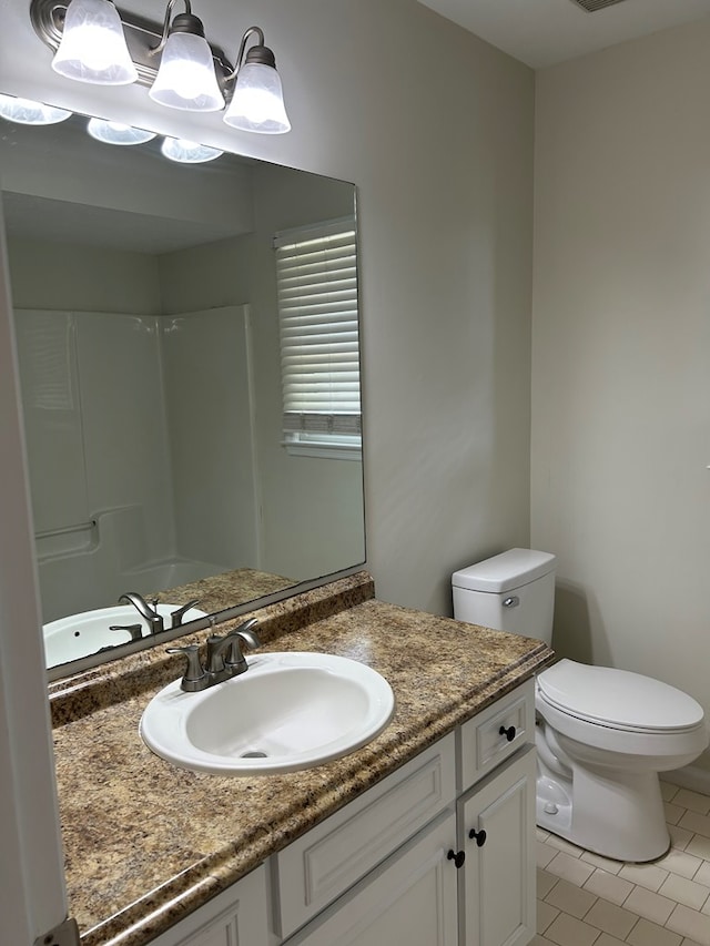 full bathroom with vanity, tile patterned flooring, toilet, and a shower
