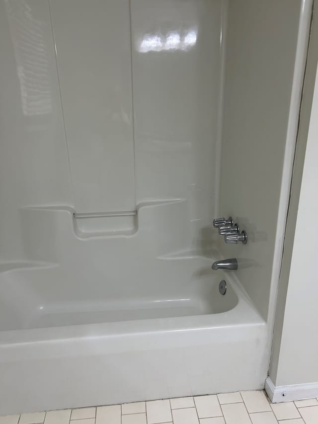full bathroom featuring tile patterned flooring and shower / bath combination