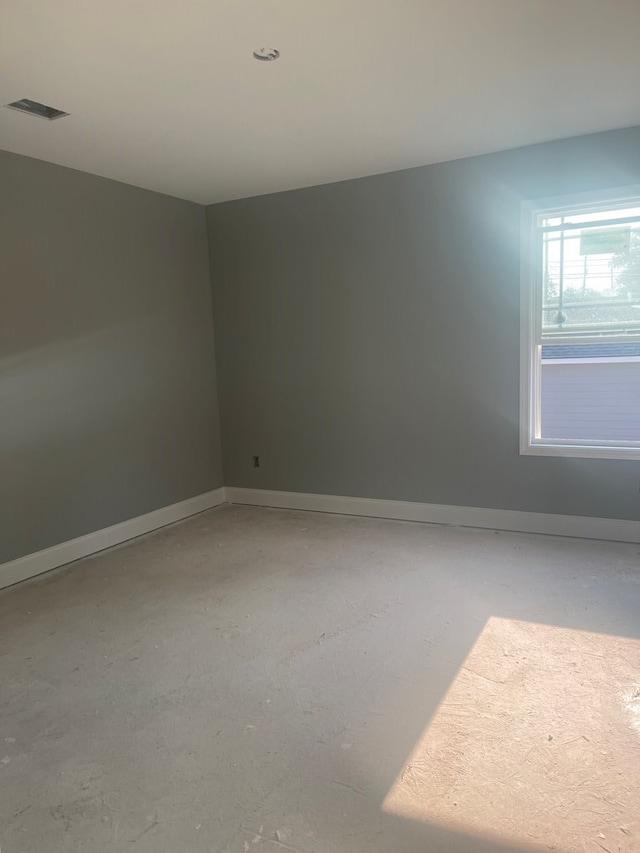 unfurnished room featuring concrete flooring