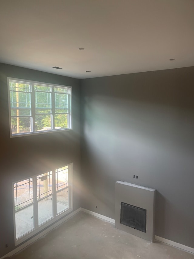 unfurnished living room with concrete floors