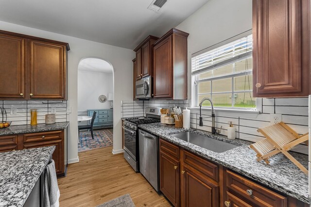 918 Dawkins Ct, Phenix City, AL 36869 - kitchen with a sink, stainless steel appliances, tasteful backsplash, and dark stone countertops