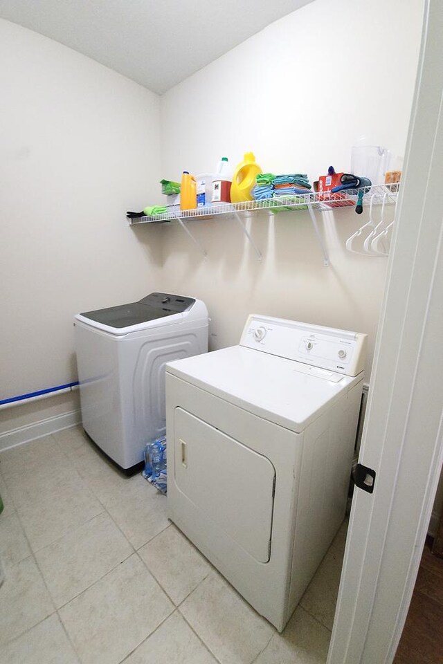 239 Clearbrook Ln, Columbus, GA 31904 - laundry room with washer and dryer and light tile patterned floors