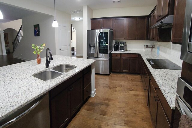 239 Clearbrook Ln, Columbus, GA 31904 - kitchen with appliances with stainless steel finishes, a sink, wood finished floors, under cabinet range hood, and dark brown cabinets