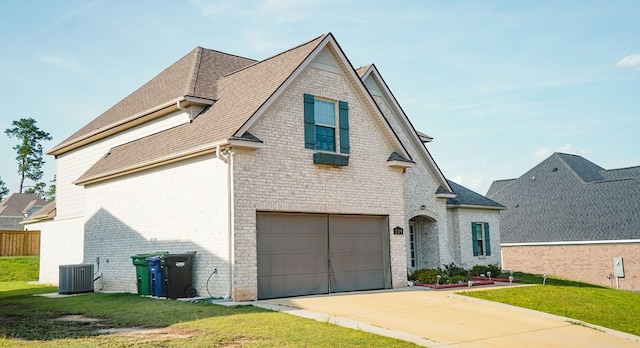 239 Clearbrook Ln, Columbus, GA 31904 - view of front of house featuring an attached garage, brick siding, a front yard, central AC unit, and driveway