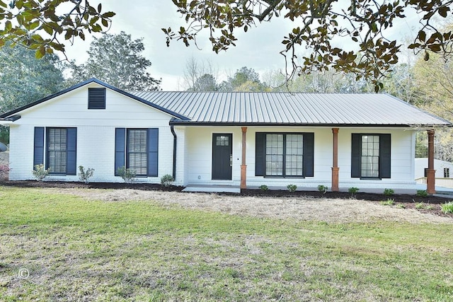 single story home featuring a porch, a front yard, brick siding, and metal roof