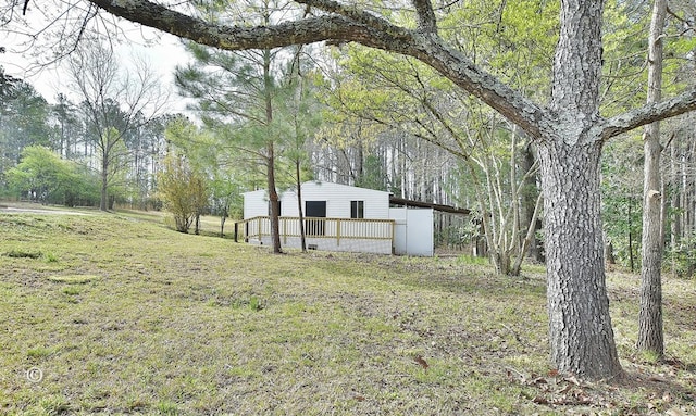 view of outbuilding with an outdoor structure and a forest view