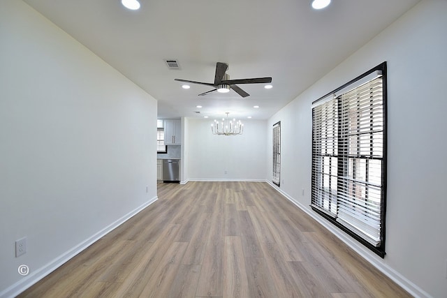 unfurnished living room with recessed lighting, wood finished floors, visible vents, and baseboards