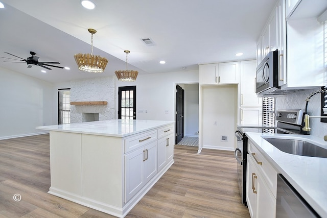 kitchen with recessed lighting, visible vents, white cabinetry, appliances with stainless steel finishes, and light wood finished floors