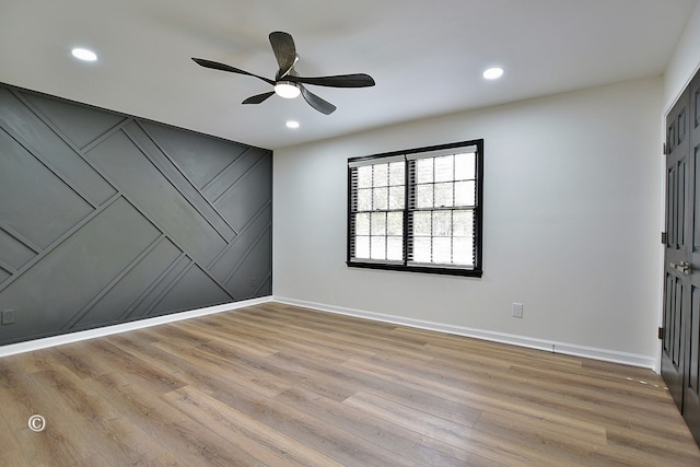 unfurnished room with light wood-style floors, baseboards, and recessed lighting