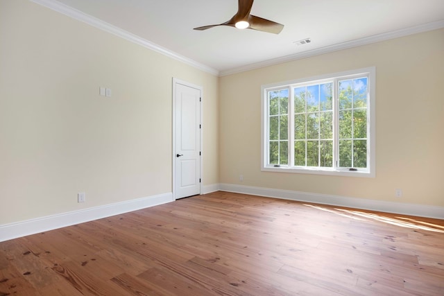 empty room featuring ceiling fan, light hardwood / wood-style floors, and crown molding