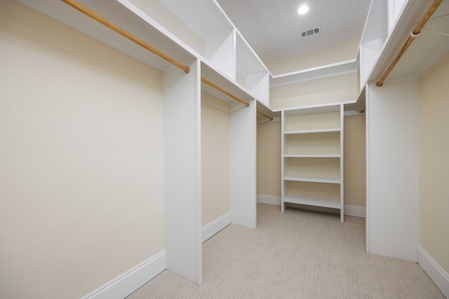 spacious closet featuring light carpet